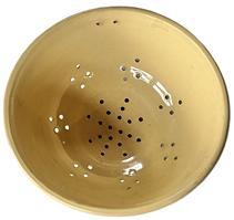 L47 Scarce 19th century Yelloware / Yellow ware Stoneware Colander. There is a set of hanging holes up by the rolled rim, and a series of diamond-shaped holes that surround the footed base. The pattern of holes within the footed base create a snowflake style pattern. Excellent condition. Measurements: 9 ¼ x 9 ¾ diameter x 4 tall.