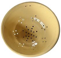 L47 Scarce 19th century Yelloware / Yellow ware Stoneware Colander. There is a set of hanging holes up by the rolled rim, and a series of diamond-shaped holes that surround the footed base. The pattern of holes within the footed base create a snowflake style pattern. Excellent condition. Measurements: 9 ¼ x 9 ¾ diameter x 4 tall.  