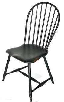 L65 Late 18th century to early 19th century New England, seven spindle bow back Windsor Chair bearing old black over original Windsor green painted surface. Sturdy shaped plank seat rests on splayed bamboo-style turned legs. Measurements: Seat is 16 ¼ deep x 16 ½ tall. Back is 18 wide x 35 ¾ tall.