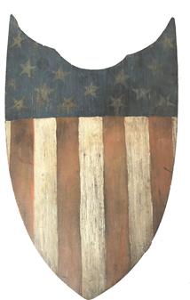 RM1022 Outstanding Patriotic Shield with 13 star American flag In the United States, wooden patriotic shields were first designed to commemorate the Centennial International Exhibition of 1876 (a World's Fair held in Philadelphia, Pa., to celebrate the 100th anniversary of the signing of the Declaration of Independence). This circa 1875 hand-painted patriotic shield (24"W x 15 1/2"H) is made of pine.