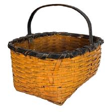 **SOLD** M48 Early woven splint Gathering Basket with sturdy steamed and bent, notched handle with original black paint on the rim and handle, and original pumpkin paint on the rest of the basket. Basket construction boasts a tightly woven decorative double rim with oval opening tapering to a rectangular bottom. The double rim is double wrapped on the sides, and single wrapped on one end, with losses to the wrap on opposite end. Measurements: 14 ½ x 11 ½ top opening. Bottom is 11 ½ x 7 ½. The sides are 6 ½ tall. Overall height is 11 ½ tall including handle.