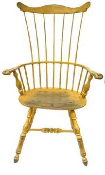 E494A Bench made Philadelphia seven spindle comb back Windsor Armchair bearing beautiful yellow painted surface. Measurements: Seat is 21 wide x 15 ¾ deep x 17 ½ tall. Overall height in back is 44 ¾ tall. 27 across arms.