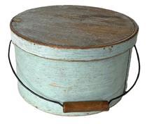 L245 Early 19th century New England bail handle pantry box retaining its original light blue painted surface. Heavy construction with overlapping steamed and bentwood sides secured by small tacks. The sides of the pantry box are fitted with a pair of oval stamped tin handle mounts that secure an arched wire swing handle with wooden hand grip with great patina from years of use. Interior retains its natural patina surface. Measurements: 11 ¾ diameter x 6 3/8 tall.
