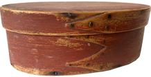F36 mid-19th century. Bentwood construction having tacked lap joints, Oval pantry Box in the original dry red paint with three finger laps