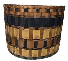 Native American Indian Penobscot band basket, ca. 1860 This form of basket is referred to as a "band" basket from the brightly colored splints used in the piece. Cadmium yellow, Prussian blue and indigo were swabbed onto the exterior surface of the splints only. Such commercially produced pigments were costly and used sparingly. Band baskets were destined for home use to store hats, clothes or linen, or for use in travel as "suitcases."measurements 11 1/2” tall. 15” diameter