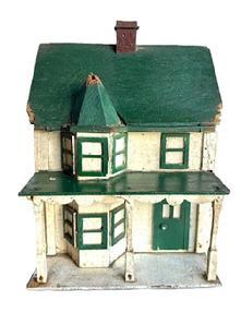 L310 Folk Art Bird House bearing its original green, white and Spanish red painted surface. It has two chimneys and a lot of character with the front bump out with hexagonal roof, overhanging porch with scalloped trim and individual posts, and applied windows and doors. The wood is pine with small wire nail construction. Early to mid-20th Century. Measurements are: ~17 ¼ deep x ~ 10 ¼ wide x ~15 tall.