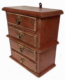 **SOLD** J262 Small hanging stack of drawers bearing early red painted surface with pinstriping on drawer fronts. Drawers are dovetailed. Combination of T and wire nail construction. Great wear. Measurements: 10 ¾ wide x 5 ½ deep x 11 ¾ tall