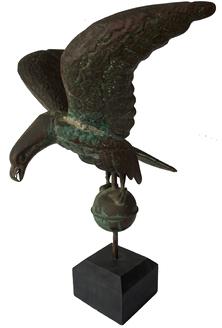 F104 19th Century full body eagle weathervane in beautiful old surface on a wooden base. This is an outstanding example of a full bodied iconic American symbol with outstretched wings and open beak with tongue perched upon a ball. It is composed of molded sheet copper and has great detail, including full legs, feet and talons with embossed feathers and broad tail. It has been mounted for display. Height with stand measures: 23”, head to tail: 15”, wing span: 18”.