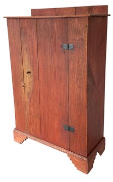 F188 Mid19th century Eastern Shore of MD heart pine ( yellow pine) Storage Cupboard with a single one door consisting of two ship lapped boards with two batons resting on a beautiful applied saw tooth base. The back boards are held in place with square head nails and are three inch higher than the case to keep things from falling behind the cupboard. In a red wash paint and all square head nail construction. (Circa 1850-1860) 37”L x 15 1/2”D x 56 1/2”T