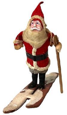 K1881 Santa on cardboard skis with wooden ski pole and a linen sack on his back. Bottom of skis is stamped "Made In....(illegible)". Approximate measurements: 5" long x 1 1/4" wide x 4" tall.