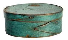 L468C Small 19th century New England oval pantry box in its beautiful original blue paint. Overlapping opposing fingered body and lid. Copper tack and tiny wooden pegged construction. Natural patina interior. Very sturdy. Measurements: 5 ½ x 4 1/8" oval x 2 1/8" tall.
