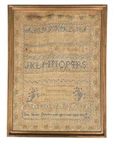 K37 Early 19th century hand wrought Sampler with two sets of alphabets in varying stitch styles with a very intricate floral and vine outer border and detailed inner border and row dividers. The blues, greens, ecru and tans are hand stitched onto a linen background. The maker stitched: Eliza Johnson Dennys'es work aged 8 years Aprile the 25th 1824" along the bottom rows, along with a central verse with flowers on each side. The verse reads: "Teach me to feel another's woe, To hide the fault I see, That mercy I to others show, That mercy show to me". (This is a verse by English Poet, Alexander Pope.) The sampler is encased within an early wooden frame with remnants of gold paint. Overall Frame size measures: 14" wide x 18 ½ tall. Sampler opening measures: 12 ½ wide x 17" tall.