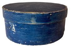 K1872 19th century New England Pantry Box bearing early soldier blue over original white painted surface. The steamed and bentwood constructed sides and rim of lid are secured to the top and bottom with tacks and tiny wooden pegs. Measurements: 6 3/4" diameter x 2 7/8" tall.