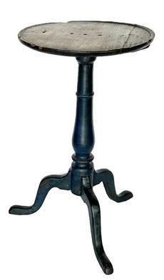 L11 Fantastic 18th century Mid-Atlantic Chippendale painted pine candlestand featuring a carved dish-rim around the top, turned pedestal and arched tripod snake legs retaining a wonderful original old blue painted surface. The legs are dovetailed into the center column. The wood is yellow pine. Great wear to top indicating years of use. Measurements: 15 ½ diameter top x 27 tall.