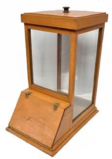 M165 Very early 20th century Country Store Showcase bearing its original pumpkin painted surface features a wooden frame with glass panels, a removeable wooden lid on top, and a hinged lift lid on one side. JOHN BOYD CO - LYNN MASS is branded inside along the top edge, with the number 2760 stenciled in black close by. A large black lettering stencil covering the bottom reads: This case is loaned for the display of REVERE BEACH POTATO CHIPS ONLY and is the property of John Boyd Company Lynn Mass. No. 2760 1912. Overall measurements: 18 ¾ deep x 12 ¾ wide x 23 tall (not including the knob).
