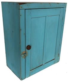 RM1036 19th century Hanging Cupboard, in original blue paint, found in New England circa 1880. A great cupboard, with the look of 19th century with double flat panel door which still retains its original iron hinges. The interior has three shelves. It is round nails construction with some square head nails. Measurements are: 26" tall x 21 1/2" wide x 12" deep