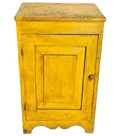 **SOLD** M125 Wonderful mid-19th century Pennsylvania one door cupboard in original yellow painted surface with a beautiful, raised panel door that is fully mortised and pegged, resting on nice cut out apron and feet. Two board back and clean, natural patina interior with sturdy shelf for storage. The wood is pine with square head nail construction. Circa 1850s-1860s. Measurements 18 ¼ wide x 15 deep x 29 ½ tall.