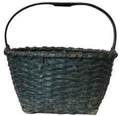 **SOLD** K1625 Exceptional 19th century tightly woven splint gathering basket bears its original dark Windsor green painted surface and a hand carved, steamed and bent, notched handle with notched grip. The two sturdy, hand-hewn, steamed and bent rims encircling the top are single wrapped and secure. Measurements: Top opening is 16 ½ x 15 diameter. The 8 ½ tall sides taper down to a 10 square bottom. Overall height is approximately 15 ½ tall including handle.