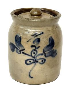 M162 Small Cobalt Decorated Stoneware Lidded Jar featuring Tulips and 1/2 (in freehand) on front. Dark brown glazed interior. Measurements: 5 ½ top outside diameter x 5 ¾ bottom diameter x 7 ½ tall. Lid is 4 ¼ diameter and appears to be original.