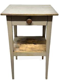 L409 Late 19th century Pennsylvania tapered leg side table with drawer and shelf below, bearing old gray painted surface. The wood is pine with square head nail construction with the legs and apron being fully mortised and pegged and the drawer being dovetailed. Circa 1860s. Measurements: 19 1/8 wide x 18 ½ deep x 30 ¾ tall. 13 clearance from bottom shelf to floor. 11 ¼ clearance between lower shelf and apron.