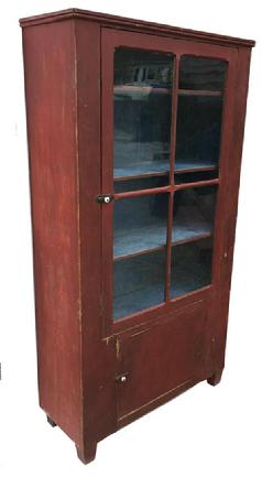 D171 19th century Caroline County , Chimney Cupboard circa 1850 with glass door and over sized window lites, with the original red painted exterior and the original dry blue painted interior.Over a single board door with bread board ends. Applied beaded molding at the top, the wood is white pine. This Cupboard came out of an estate here in Caroline County Maryland. Measurements are: 70 1/4" tall x 37 1/2' wide x 15" deep