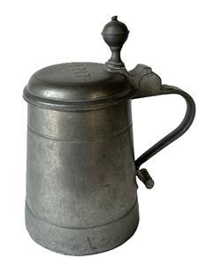 K153 Early 19th century pewter tankard with round knob finial and owner’s initials, “I.M.T.”, decoratively engraved on top of the hinged lid. Stamped inside lid with double hallmarks. Heavy, cylindrical style body with sturdy handle. Great patina and wear indicative of use, including a few tiny holes along an interior line of corrosion to the metal. Measures 7 ¼” inches tall with a 4 3/8” diameter base.