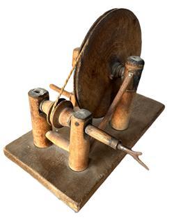 L24 Late 18th century to early 19th century handmade wooden Apple Peeler / Parer. Solid wood with small cut nail construction. The cord-powered mechanism is essentially a wheel and pulley system that uses a large wheel to drive a smaller wheel with an adjustable threaded belt tightener. A patent was granted in New York for a similar style wooden apple peeler / parer in December 1829. Approximate measurements: 12 ½ long x 6 ¼ wide x 9 tall.