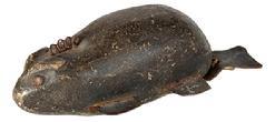 L505 Hand carved wooden Beaver fishing decoy with leather tail, imbedded metal weights, tin legs and tack eyes. Original painted surface. Approximate measurements: ~8" long x ~3 5/8� wide x ~2 &frac12;� tall. 