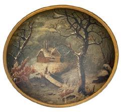 L119 19th century hand polychrome painted wooden bowl with a winter landscape scene of house by a stream in the snow with a bundled-up person standing on a wooden bridge in the forefront. Unsigned. The bowl is in good condition with no cracks or breaks. Slightly out of round. Measurements: 14 x 13 ½ diameter x 3 ¼ tall.