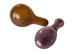 K1700B Group of two hand blown glass sock darners. One is amethyst with prominent bubbles in the glass and measures approximately 5 ¼ long x 2 wide x 1 ½ thick. The other is heavy amber blown glass with prominent bubbles in the glass, rough cut pontil and measures approximately 5 long x 3 diameter on one end and 1 diameter on the opposite end.