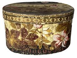 K254 Dated and identified 19th century Pennsylvania oval wallpaper box signed Laura Krauss 1832 in pencil on the bottom. The box is paperboard, hand stitched construction and is covered in a floral wallpaper in rich earth tones. Nice condition. Measurements: 8 ¼ long x 6 ½ wide x 4 3/8 tall.