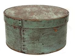 J454 New England 19th Century Pantry Box with old robin egg blue painted surface over the original red. Steamed and bentwood sides are secured with small metal tacks. The band is pegged on to the lid. Natural patina interior. Measurements: 10¾” diameter x 5¾” tall