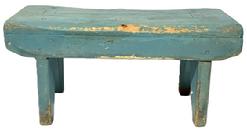 M143 19th century Pennsylvania Stool in its old blue paint over the original red paint with the initials H F on the bottom of one apron. Drop aprons with shaped ends adorn both sides of the stool. Legs are single mortised through the top and end in boot jack cut-out feet. The wood appears to be pine with square head and wire nail construction. Measurements: 17 ¾ long x 7 ¾ wide x 8 tall.
