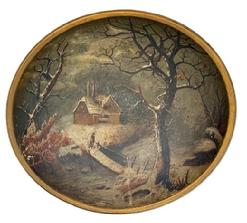 L119 19th century hand polychrome painted wooden bowl with a winter landscape scene of house by a stream in the snow  with a bundled-up person standing on a wooden bridge in the forefront. Unsigned. The bowl is in good condition with no cracks or breaks.  Slightly out of round. Measurements: 14 x 13 ½ diameter x 3 ¼ tall. 