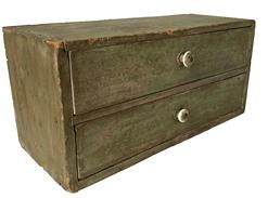 F130 19th century set of two drawers, all original in old green paint with the original knobs on the drawers. The case is nail construction with square head nails. Measurements: 16" wide x 7 ½” deep x 7 ½” tall