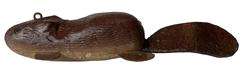 F195 Beaver fishing decoy with leather tail, metal weights, tin legs and carved eyes. From the collection of Barry Nelson. 7" long