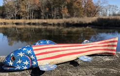 E529 PATRIOTIC FLAG FISH DECOY FOLK ART PATRIOTIC Fish Decoy is hand carved the metal fins and line ties actually guide the decoy through the water decoy is approximately 12”