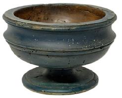 M1117 Mid-late 19th century wooden footed compote retaining its old blue paint. The raised lip around the top edge and wonderful turnings gracefully encircling top and bottom add a decorative look to this functional piece. Measurements: 9 ¾ top diameter x 6 ¾ bottom diameter x 6 ¼ tall.