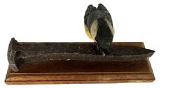 M293 Exceptionally detailed hand carved and painted Folk Art carving of a Chickadee with a sunflower seed perched on an Iron Railroad Spike (all wood) signed and dated Ciesielski 2001 on the bottom. The carver, Vincent A. Ciesielski (b. 1938 d. 2021) of Harrisburg, West Hanover Township, Pennsylvania, is known for his realistic, superb details in each lifelike carving. Overall measurements: 7 ¾ x 2 3/8 x ~3 ¼ tall.