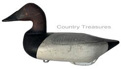 RM1051 Early Bob McGaw Canvasback Drake decoy. Paint is a second coat of working paint, also done by McGaw. Original “dog bone” weight and iron ring on bottom. Measures approximately 16” long x 6 3/4” wide x 7 1/2” tall