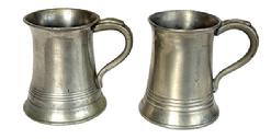 L269A Pair of Pewter mugs each is marked ½ Pint. One has the initials "M.b." engraved on the bottom. Each measures approximately 3 3/8 bottom diameter x 3 top diameter x 4 tall.