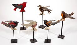 E217 SIX, carved and painted wooden Birds with stand for displaying , painted like a Baltimore Oriole . Each with an old painted surface. 7 1/2" to 10" HOA.