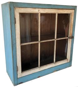 SB2 Early 19th century Burks County Pennsylvania painted pine hanging cupboard, retaining original blue and white painted surface, one single door with six window lites, old wavy glass with a dovetailed case top and bottom, the interior of the cupboard unpainted natural surface. the door is full mortised Measurements are" 38" high., 38 1/2" wide., 15" deep .
