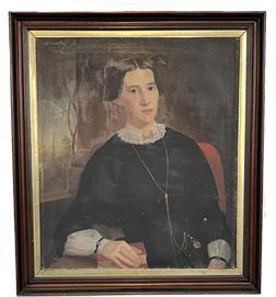 K1522 19th century American School Oil on Canvas Portrait of a Woman. Some of the exceptional details within this portrait include ultra realistic facial features, a lace collar with beautiful broach, a long gold chain with watch, decorative sleeve “bracelets” with blue / red colored beads/jewels, and a book beneath the finely detailed fingers of her right hand. A curved trellis and the tall steeple of a church are visible in the through the window painted in the background. Very small hole in canvas by her left forearm. Framed measurements: 30 ½” wide x 2” thick x 34 ½” tall. Canvas measures 25 ¼” wide x 29 ¼” tall