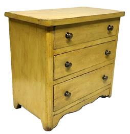 **SOLD** M220 Diminutive late-19th Century Pennsylvania mustard painted childs chest of drawers featuring decorative cut out drop apron on front, rounded front corners on top as well as chest, cut out feet and three drawers with brass knobs. The woods are pine and walnut with small wire nail construction. Circa 1890s. Measurements: 14 ¾ wide x 8 ½ deep x 13 ¾ tall.