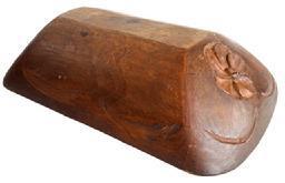 SP13 Wooden trencher bearing hand carved flower blossom on each end and hand carved wheat on each side. A double beaded edge encircles the top lip/rim with hand carved decoration within the lip on each end. Hand chopped construction from a single piece of wood with natural finish. Wonderful natural patina interior with evidence of significant chop and tool marks from years of use. The wood appears to be walnut. Measurements: 20 ¼ long x 13 wide x 4 ¼-4 ½ tall, depending on where measured. Trencher sides taper down to a flat bottom area that measures 11 3/8 long x 3 ¼ wide.