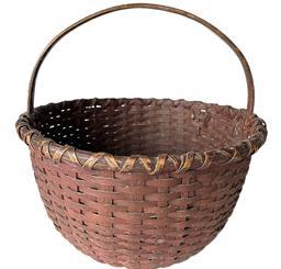 **SOLD** K1626 Sturdy 19th century original dark red painted round woven splint basket with hand-carved steamed and bent handle that is woven into the sides. Double wrapped rim. The tightly woven bottom includes a slightly bumped up interior for airflow. Measurements: 15 top diameter x 16 tall with handle. The sides are ~8 ½ tall.