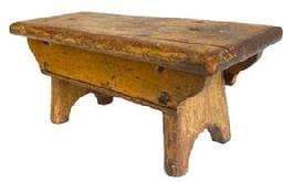 **SOLD** K1610 19th century Pennsylvania original mustard painted footstool boasting half-moon cut out feet and double drop aprons bearing shaped ends and a beaded edge. Top bears rounded edges on all sides. The wood is pine with square head nail and early screw construction. Very sturdy. Circa 1850s. Measurements: 14 long x 5 ¾ wide x 6 ¼ tall.