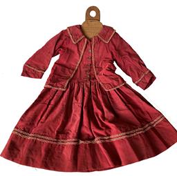 F162 Late 19th century Wonderful child’s dress with a mock jacket front and garibaldi style sleeves on wooden hangar monogrammed with the initials “KAR”. Dress is made of what appears to be a taffeta type fabric