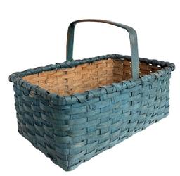 **SOLD** M141 Early 20th century hand woven splint Basket from Eastern Shore, Maryland with beautiful blue paint. Sturdy rectangle shape with a double wrapped, double rim and a steamed and bent handle that is woven into the sides and secured with tiny tacks. Natural patina interior. Very good condition. Measurements are: 18 ¼ long x 13" wide x 13" tall including handle. The sides are 7 ½ tall.